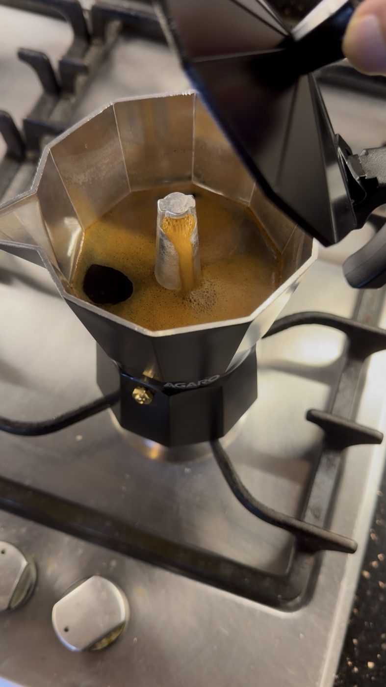 Coffee brewing in a moka pot on the stove