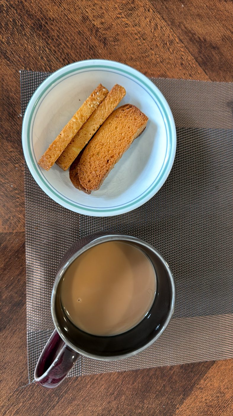 Cup of chai with rusks on a plate